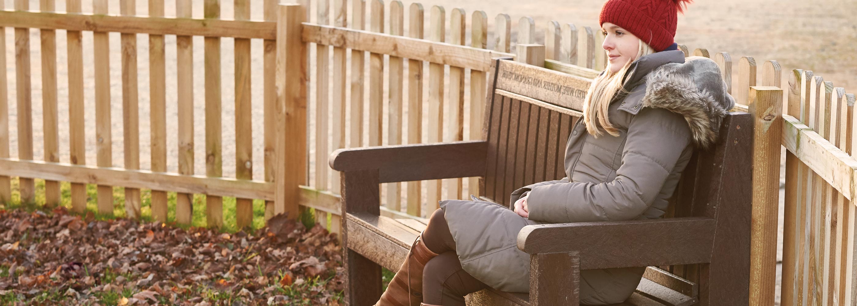 Woman sat on a memorial park bench